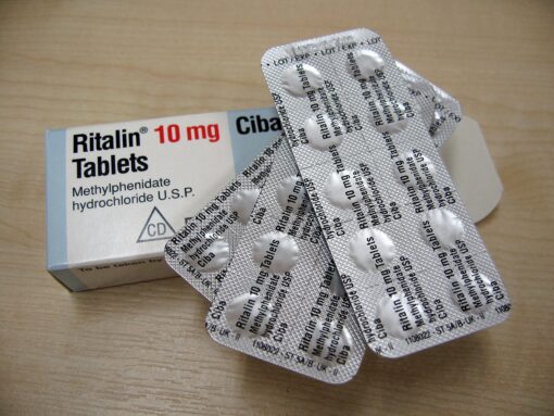 Ritalin medication bottle with pills, commonly prescribed for ADHD and narcolepsy treatment.