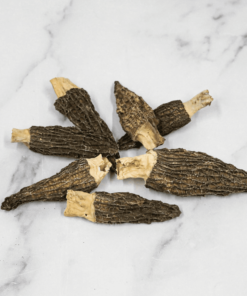 A close-up of dried morel mushrooms, showcasing their unique honeycomb-like texture and earthy brown color, perfect for cooking and adding rich flavor to dishes.