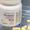 A close-up image of Vyvanse (Lisdexamfetamine) capsules, a prescription medication used to treat ADHD and binge eating disorder.