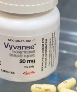 A close-up image of Vyvanse (Lisdexamfetamine) capsules, a prescription medication used to treat ADHD and binge eating disorder.