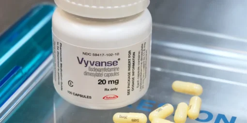 A close-up image of Vyvanse (Lisdexamfetamine) capsules, a prescription medication used to treat ADHD and binge eating disorder.