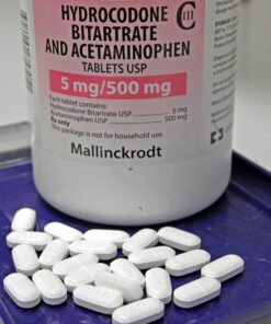 An image of hydrocodone pills, often used for pain relief, showing their typical appearance in prescription medication bottles.