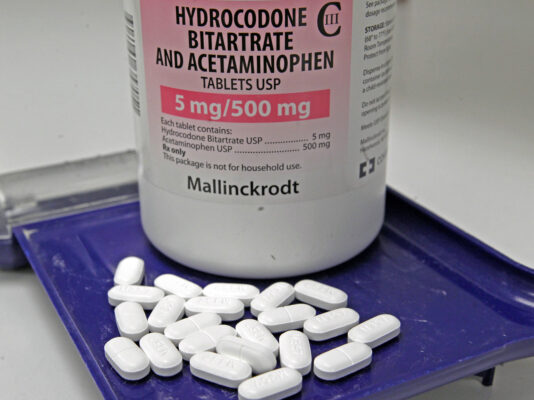 An image of hydrocodone pills, often used for pain relief, showing their typical appearance in prescription medication bottles.